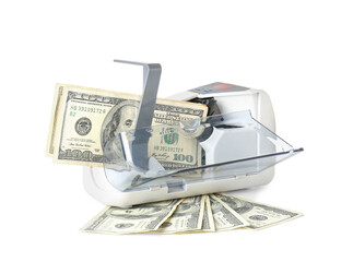 Dollars and modern currency counting machine on white background