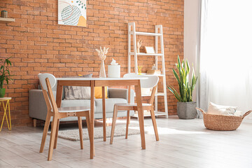Comfortable dining table in room with modern furniture