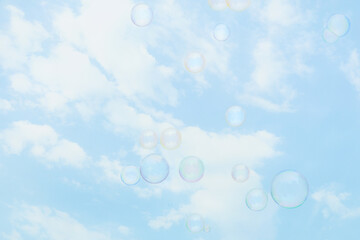 Soap bubbles on beautiful sky background