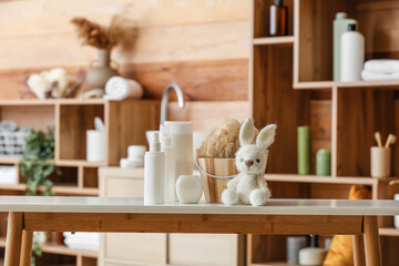 Baby bath accessories with toy on table in room