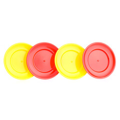 A set of children's toy dishes isolated on a white background. Plastic plates, forks and spoons. Children's kitchen. Educational role-playing games for children