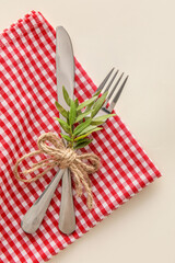 Obraz premium Napkin and cutlery on white background, closeup