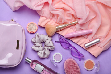 Different female accessories and cosmetic products on color background