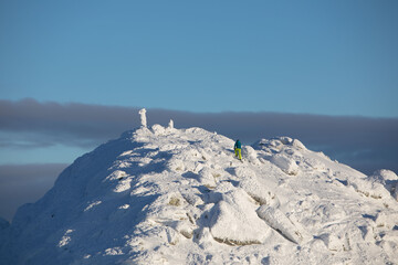 Fototapeta na wymiar people climbing to the top of snowed mountains peak