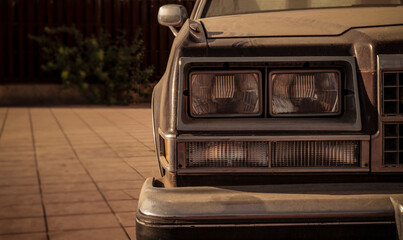 Fototapeta premium Closeup of headlights of an old, dirty car