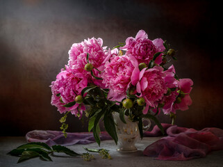 Still life with pink peonies on a dark background