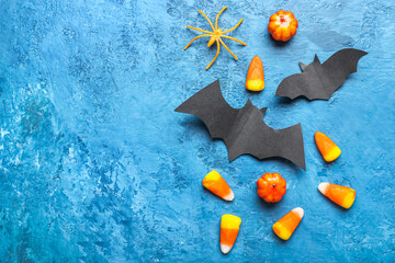 Set of different Halloween decor with paper bats on color background