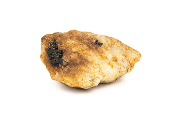 The mineral beryl is white in color with a dirty reddish coating on the surface