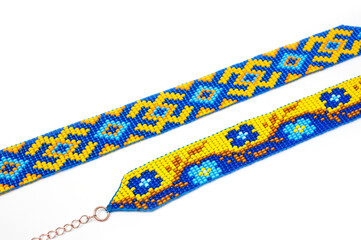 Chokers made of braided beads of blue-yellow color with Ukrainian folk patterns.