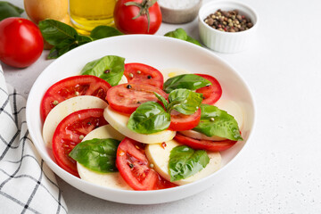 Caprese Salad with tomatoes and mozzarella with olive oil.