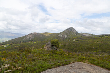 Panorama on the Paarl Rock with Mountains in the background, clouds and blue sky