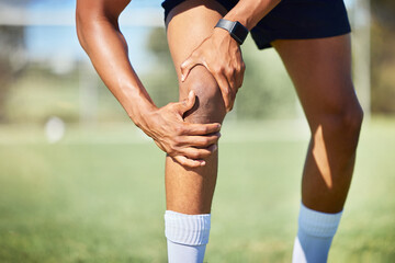 Sport injury, knee and fitness, soccer field and muscle with pain, soccer player hurt and exercise training. Athlete, hands on injured leg, physical activity and sports, healthy and active lifestyle