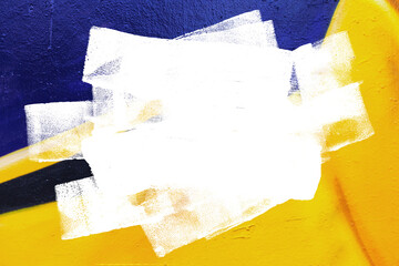 Closeup of colorful yellow and black urban wall texture with white white paint stroke. Modern...