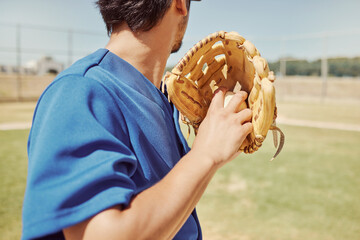 Baseball, sports and man pitching during a game, training and professional event on a field. Back of athlete ready to throw a ball with a glove during an outdoor competition, fitness or cardio