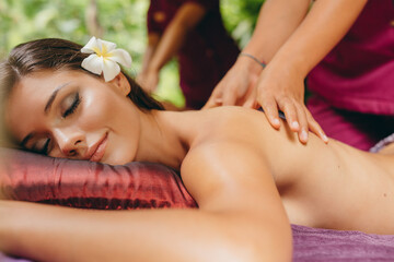 Obraz na płótnie Canvas Attractive woman getting a massage at day spa