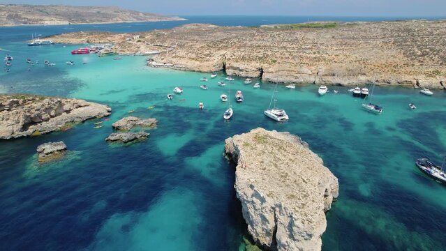 Aerial view orbiting yachts in Blue Lagoon, Malta