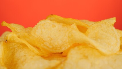 Potatoes chips, isolated on red background