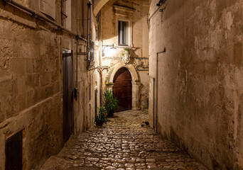 Obraz premium Cobblestone street in the Sassi di Matera a historic district in the city of Matera. Basilicata. Italy