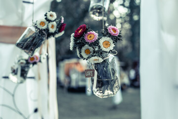 Wedding decorations Luxury original wedding floral decoration in the form of mini-vases and bouquets of flowers hanging from the ceiling.