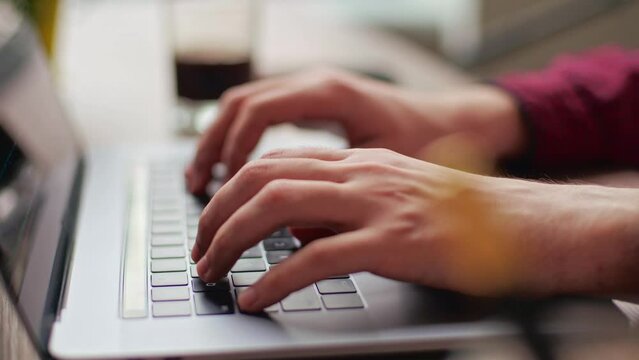 Close up of freelancer's developer hands typing program code on laptop keyboard in coworking. Businessman at work in working in office. Copywriter writing text on computer keyboard in coffeeshop.