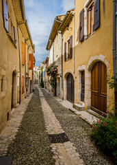 Fototapeta na wymiar Medieval houses and cobblestone street in the village of Rochemaure, in the South of France (Ardeche)