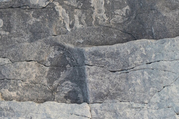 Dark gray stone with thin cracks. stone texture