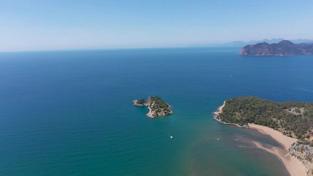 Iztuzu beach in dalyan mugla province and the island on the point that river meet with blue sea, aerial footage with drone