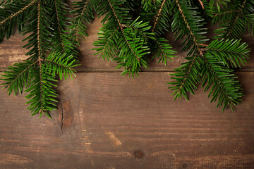 Beautiful fir branches on wooden table. Christmas decoration.