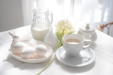 White still life in a high key with milk, eggs and a cup of cappuccino.