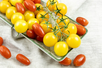 red and yellow cherry tomatoes on a plate. close-up