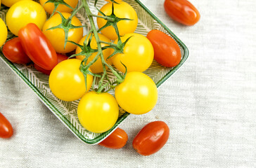 red and yellow cherry tomatoes on a plate. close-up, top view