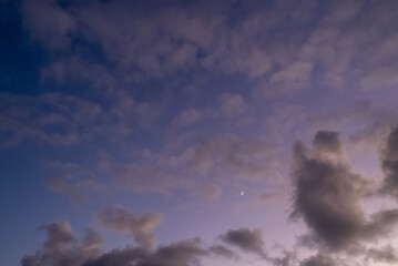 Panoramic view of a blue and purple sky with moon. Panorama background.
