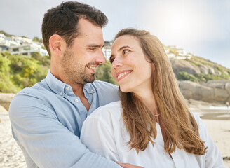 Fototapeta premium Love, bond and couple hug on the beach, relax and enjoy romantic quality time together, peace or freedom. Marriage support, partnership trust and happy man and woman travel on Canada holiday vacation