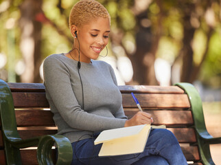 Happy, black woman and writer outdoor with music to relax, enjoy sunny day and make notes for studies. Young female, lady student with notebook and podcast, writing in diary or journal outside.