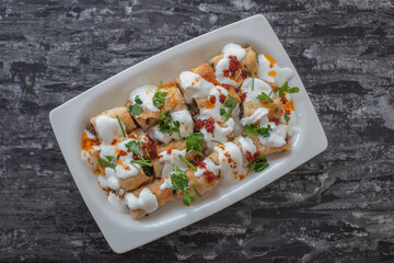 Turkish ravioli with yufka, yoghurt and minced meat; Its Turkish name is yufkalı high society ravioli.