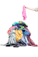 hand throws clothes into a pile with used clothes. Pile of used clothes on a light background. Second hand for recycling - 539951205