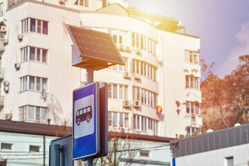 Solar panel on city road sign post, power for bus stop light, environmental friendly ecology electricity. Solar energy panel powered city infrastructure, ecological renewable solar energy