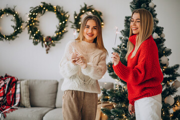 Two girls friends celebrating christmas