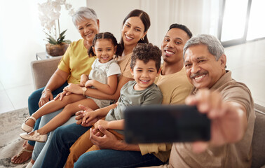 Phone, selfie and happy family on a sofa with people relax, smile and bond in a living room. Children, parents and grandparents smiling for photo while enjoying quality time on a couch in their home