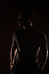 Fototapeta na wymiar Silhouette of a man in the studio
