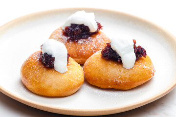 fried muffins with plum jam and sour cream