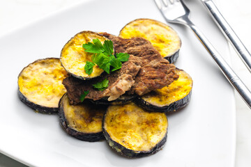 meat in breadcrumbs with grilled aubergine