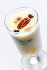vanilla custard with nuts and raisins in a glass