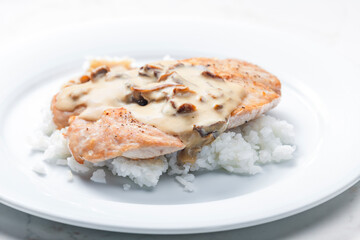 poultry meat with mushroom sauce and rice