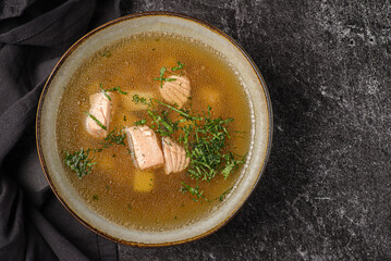 fish soup with salmon on a dark background