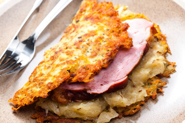 potato cakes with smoked meat and sour cabbage