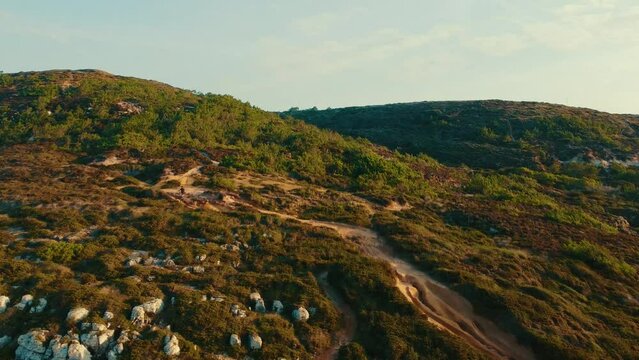 Flying Up Over Green Mountain While Person Cycling In Heart Of Nature, Ericeira Portugal