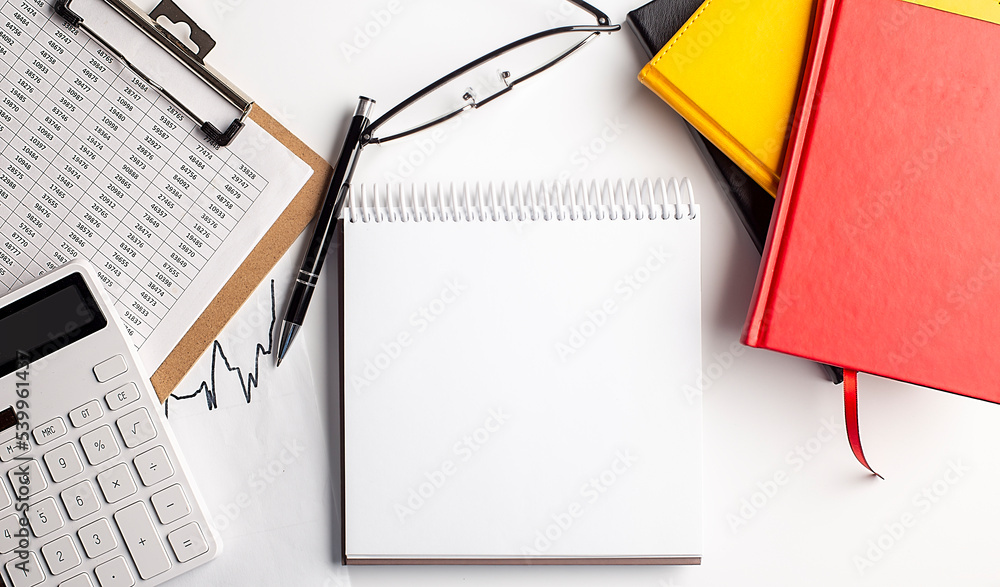 Poster notebook with clipboard, calculator and colorful notebooks , copy space