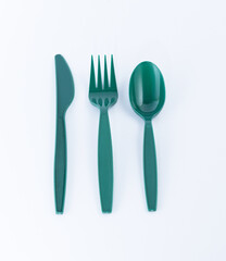 Disposable green plastic cutlery. Spoon, fork and knife.