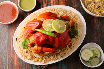 Arabic chicken Manthi or mandi cooked meat, Basmati rice with Masala, spice. Kuzhimanthi or hot and spicy Manthi on black background in Malabar Kerala, South India. Top view of Indian non veg food.
